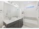 Bathroom featuring double sinks with gray cabinets, soaking tub, and tile flooring at 861 Recess Point Dr, Moncks Corner, SC 29461