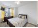 Bedroom featuring a dark wood bed, dresser, and soft yellow curtains at 861 Recess Point Dr, Moncks Corner, SC 29461