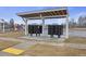Organized community mailboxes under a sheltered structure with nearby parking and playground at 861 Recess Point Dr, Moncks Corner, SC 29461