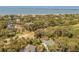 Aerial view of a home situated near the ocean, golf course, and neighboring houses at 864 Club Cottage Rd, Edisto Beach, SC 29438