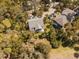 Aerial view highlighting the property surrounded by mature trees and landscaping at 864 Club Cottage Rd, Edisto Beach, SC 29438