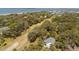 Aerial view of a home surrounded by a golf course and trees near the ocean at 864 Club Cottage Rd, Edisto Beach, SC 29438