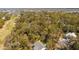 Aerial view of a home near a golf course and waterfront, surrounded by lush trees and greenery at 864 Club Cottage Rd, Edisto Beach, SC 29438