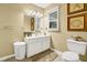 Bright bathroom with white cabinets, vanity, and decorative seashell accents at 864 Club Cottage Rd, Edisto Beach, SC 29438