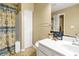 Bathroom featuring a shower with curtain and white vanity, creating a serene space at 864 Club Cottage Rd, Edisto Beach, SC 29438