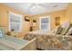 Inviting bedroom with two beds, fan and sunny windows for a cheerful and comfortable space at 864 Club Cottage Rd, Edisto Beach, SC 29438