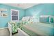 Bright bedroom featuring two twin beds, colorful decor, a window, and comfortable furnishings at 864 Club Cottage Rd, Edisto Beach, SC 29438