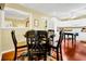 Dining area with rich wood floors, a black table set, and colorful rug at 864 Club Cottage Rd, Edisto Beach, SC 29438