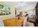 Spacious dining room with hardwood table, artwork and view into the living room at 864 Club Cottage Rd, Edisto Beach, SC 29438