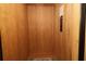 Interior view of an elevator with natural wood paneling and control panel at 864 Club Cottage Rd, Edisto Beach, SC 29438