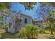 Exterior view of a white home, framed by Spanish moss-draped trees, showcasing its serene setting at 864 Club Cottage Rd, Edisto Beach, SC 29438