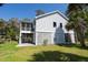 Charming two-story home with screened porch, ground level lattice enclosure, and lush landscaping at 864 Club Cottage Rd, Edisto Beach, SC 29438