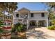 Charming elevated home with mature trees, a covered parking area, and beautiful landscaping at 864 Club Cottage Rd, Edisto Beach, SC 29438