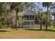 Charming two-story home with a screened porch, nestled amidst lush trees and greenery in a tranquil setting at 864 Club Cottage Rd, Edisto Beach, SC 29438