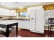 Bright, functional kitchen with white appliances, cabinets, and hardwood floors at 864 Club Cottage Rd, Edisto Beach, SC 29438