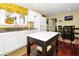 Cozy kitchen featuring white cabinets, granite countertops, and a breakfast area at 864 Club Cottage Rd, Edisto Beach, SC 29438