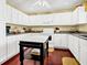 Bright kitchen featuring granite countertops, white cabinets, an island, and hardwood flooring at 864 Club Cottage Rd, Edisto Beach, SC 29438