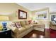 Inviting living room with hardwood floors, tan sectional, and accent decor for relaxation at 864 Club Cottage Rd, Edisto Beach, SC 29438