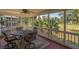 Relaxing screened-in porch with comfortable seating and views of the surrounding landscape at 864 Club Cottage Rd, Edisto Beach, SC 29438
