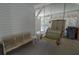 Inviting porch featuring a swing, bench seating, and a storage cabinet for relaxed outdoor enjoyment at 864 Club Cottage Rd, Edisto Beach, SC 29438