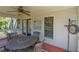Inviting screened porch with outdoor dining set, perfect for enjoying the outdoors at 864 Club Cottage Rd, Edisto Beach, SC 29438