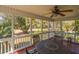 Relaxing screened porch with outdoor seating and views of lush greenery at 864 Club Cottage Rd, Edisto Beach, SC 29438