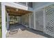 Under-deck area with swing and seating, offering a shaded outdoor space with lattice surround at 864 Club Cottage Rd, Edisto Beach, SC 29438