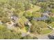 Aerial view of home with lush trees, golf course views, and neighborhood streets at 8795 E Fairway Woods Cir, North Charleston, SC 29420