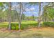 Scenic view of the manicured golf course with mature trees bordering the property at 8795 E Fairway Woods Cir, North Charleston, SC 29420