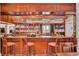 Elegant bar area with a fully stocked shelves and comfortable seating for patrons at 8795 E Fairway Woods Cir, North Charleston, SC 29420