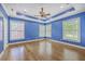 Large bedroom with tray ceiling, hardwood floors, and plenty of natural light at 8795 E Fairway Woods Cir, North Charleston, SC 29420