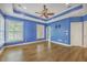 Spacious bedroom features wood floors, two windows, ceiling fan, and tray ceiling at 8795 E Fairway Woods Cir, North Charleston, SC 29420