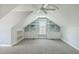 Large bonus room with built-in shelves and cabinets under eaves, and neutral carpeting at 8795 E Fairway Woods Cir, North Charleston, SC 29420