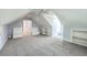 Bonus room under eaves with built-in bench seating and shelves, neutral carpeting at 8795 E Fairway Woods Cir, North Charleston, SC 29420