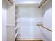 Walk-in closet with custom shelves, rods, and hardwood floor at 8795 E Fairway Woods Cir, North Charleston, SC 29420