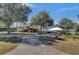 Exterior shot of a clubhouse featuring landscaped grounds and outdoor seating at 8795 E Fairway Woods Cir, North Charleston, SC 29420