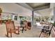 Relaxing outdoor patio with comfortable seating, overlooking the clubhouse grounds with mature trees at 8795 E Fairway Woods Cir, North Charleston, SC 29420