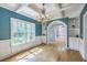 Spacious dining room boasts hardwood floors, a coffered ceiling, wainscoting, and a large window for natural light at 8795 E Fairway Woods Cir, North Charleston, SC 29420