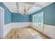 Dining room with hardwood floors, blue walls, a coffered ceiling, wainscoting, and a large window at 8795 E Fairway Woods Cir, North Charleston, SC 29420