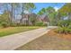 Charming two-story brick home with a long driveway, attached garage, and well-maintained landscaping at 8795 E Fairway Woods Cir, North Charleston, SC 29420