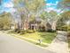 Attractive two-story brick home with a well-maintained lawn and mature trees in a peaceful neighborhood at 8795 E Fairway Woods Cir, North Charleston, SC 29420