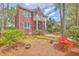 Attractive two-story brick home with a balcony, landscaped front yard, and inviting curb appeal at 8795 E Fairway Woods Cir, North Charleston, SC 29420