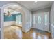 Bright foyer featuring hardwood floors, an ornate front door, and an archway leading to the dining room at 8795 E Fairway Woods Cir, North Charleston, SC 29420