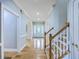 Spacious foyer featuring hardwood floors, staircase, and a decorative front door at 8795 E Fairway Woods Cir, North Charleston, SC 29420