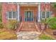 Close up of front entry with brick steps, black door, and charming details at 8795 E Fairway Woods Cir, North Charleston, SC 29420