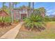 Charming two-story brick house with lush landscaping, a cozy front yard, and inviting curb appeal at 8795 E Fairway Woods Cir, North Charleston, SC 29420