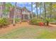 Beautiful two-story brick home with a well-manicured lawn, mature trees, and charming curb appeal at 8795 E Fairway Woods Cir, North Charleston, SC 29420