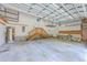 Spacious garage with high ceilings, shelving, a staircase, and ample storage, perfect for a workshop or parking at 8795 E Fairway Woods Cir, North Charleston, SC 29420