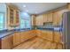 Modern kitchen featuring wood cabinets, stainless appliances, and stone countertops at 8795 E Fairway Woods Cir, North Charleston, SC 29420