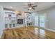 Spacious living room features hardwood floors, a fireplace with built-ins, and access to an outdoor area at 8795 E Fairway Woods Cir, North Charleston, SC 29420